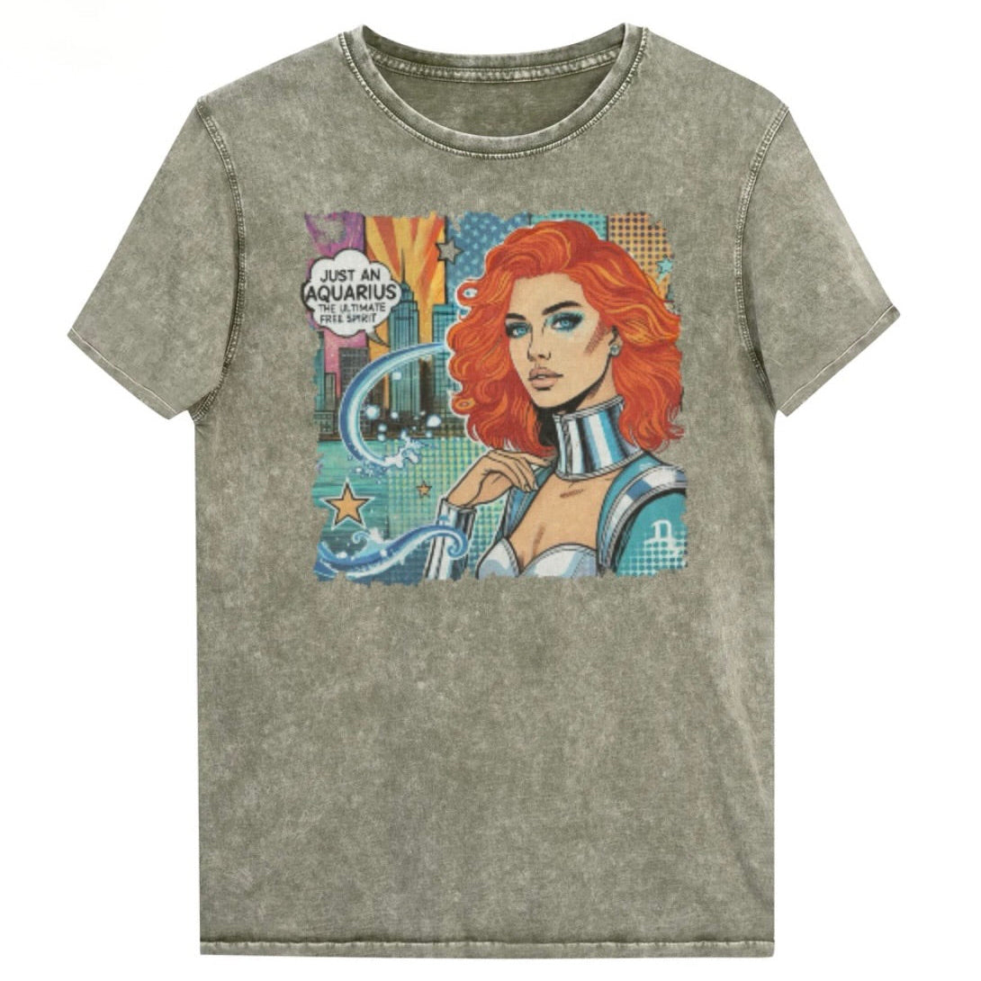Flatlay of a unisex army green denim wash vintage t-shirt with a retro pop-art Aquarius graphic showing the head and shoulders of a redhead woman with blue highlights wearing a sci-fi type silver choker and outfit, with a city background with tentacles and stars captioned, "Just an Aquarius, the ultimate free spirit". Branded Redblonde in red on inside neck and right shoulder