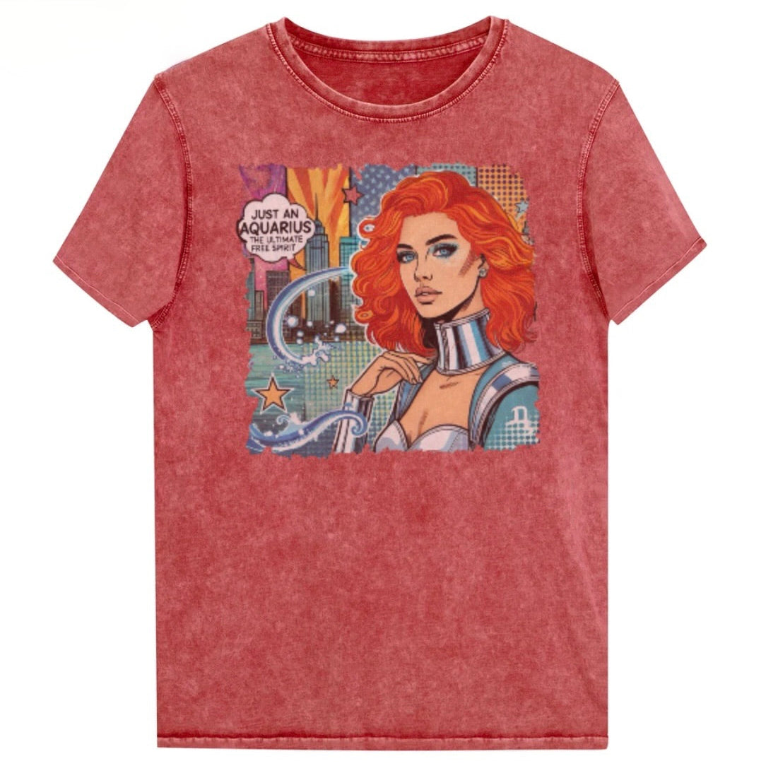 Flatlay of a unisex garnet red denim wash vintage t-shirt with a retro pop-art Aquarius graphic showing the head and shoulders of a redhead woman with blue highlights wearing a sci-fi type silver choker and outfit, with a city background with tentacles and stars captioned, "Just an Aquarius, the ultimate free spirit". Branded Redblonde in red on inside neck and right shoulder