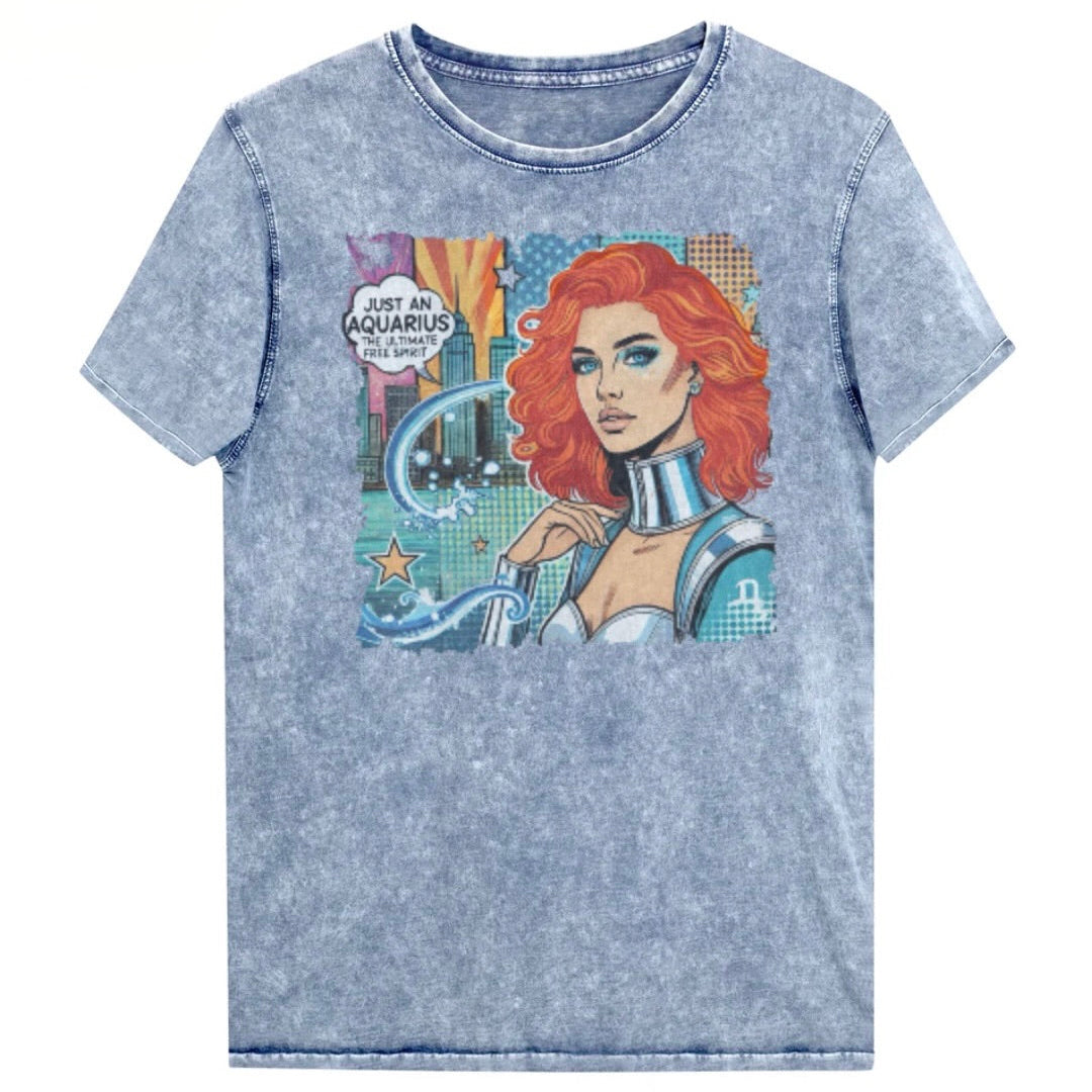 Flatlay of a unisex blue denim wash vintage t-shirt with a retro pop-art Aquarius graphic showing the head and shoulders of a redhead woman with blue highlights wearing a sci-fi type silver choker and outfit, with a city background with tentacles and stars captioned, "Just an Aquarius, the ultimate free spirit". Branded Redblonde in red on inside neck and right shoulder