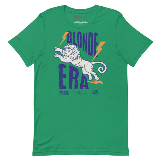 Kelly Green unisex short-sleeve t-shirt featuring a bold graphic of a leaping lion outlined in purple, surrounded by orange lightning bolts. The text “BLONDE ERA” appears in large distressed purple letters, with smaller text reading “LION-LIKE STRENGTH” and “TRUE POWER” underneath. Signed RedBlonde. The brand name “RedBlonde” is printed in red on the inside collar label and on the right sleeve near the cuff.