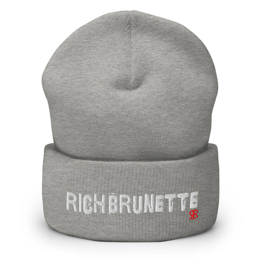 Light Grey Rich Brunette knitted beanie with the embroidered phrase “Rich Brunette” in white script and a small red RB logo on the fold-over cuff, displayed against a clean white background.
