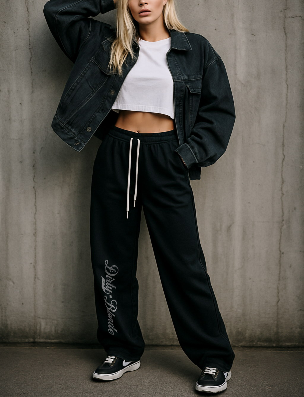 Model wears relaxed-fit straight joggers with white drawstrings and vintage-style “Dirty Blonde” milkstore script printed vertically down the leg — bold, effortless and unmistakably RedBlonde.