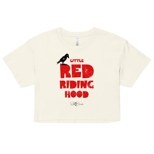 Natural-colored women’s crop top featuring bold distressed red Love Birds font reading “Little Red Riding Hood” with a small black crow perched on the word “Little,” and the RedBlonde signature logo below.