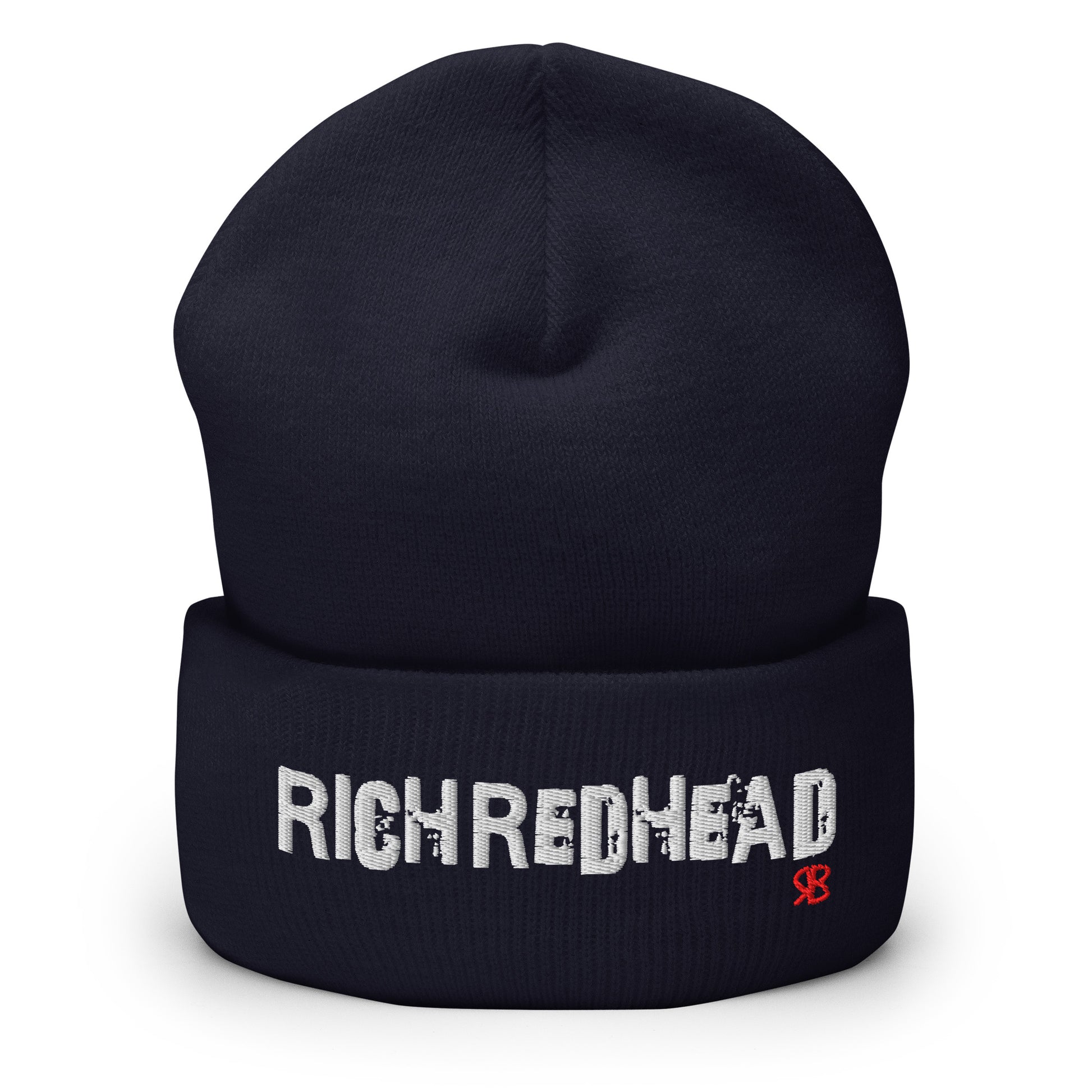 Navy cuffed beanie with the embroidered slogan “RICH REDHEAD” in bold white distressed-style lettering, featuring a small red “RB” RedBlonde logo on the right side of the fold. The beanie is shown upright against a clean white background.