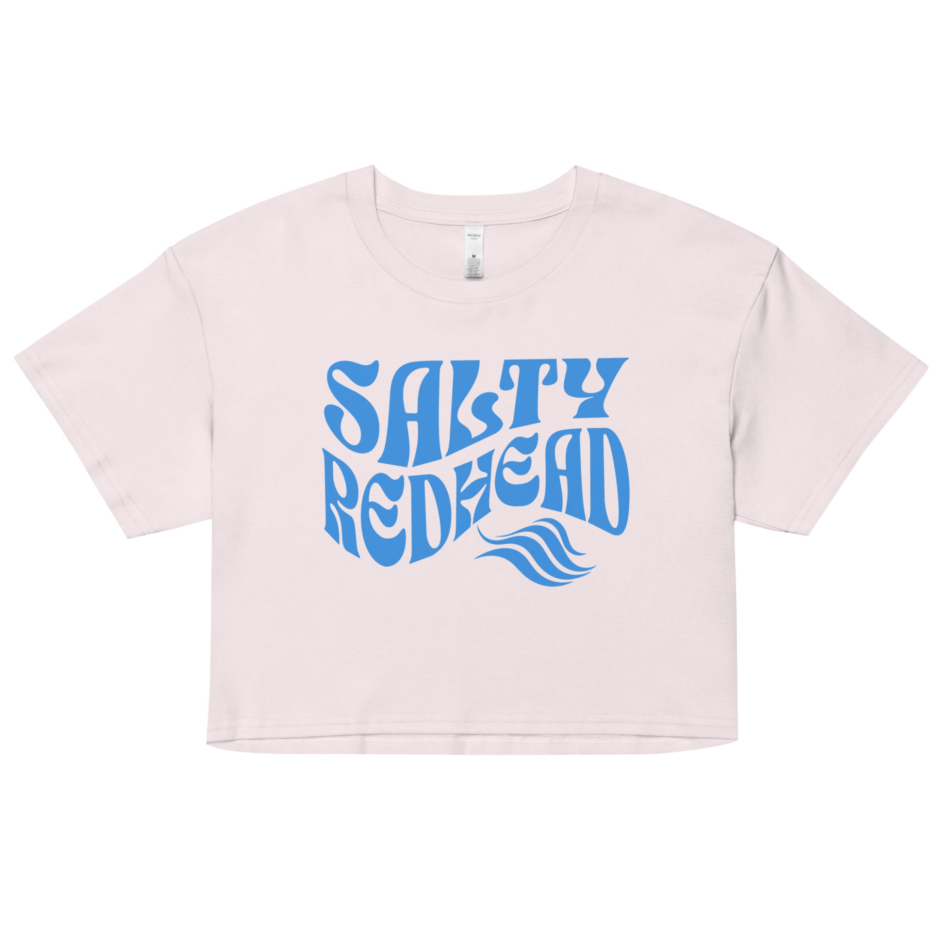 Flatlay of a orchid-white loose women's crop top t-shirt with the words ‘Salty Redhead’ in retro 70s text in blue. branded redblonde on inside neck and right shoulder