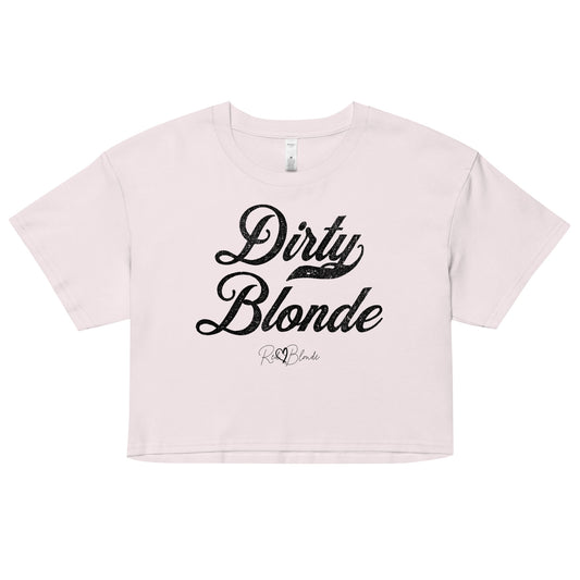 Orchid women’s crop top featuring the phrase “Dirty Blonde” in bold, black milkstore vintage-style script across the chest. Below the phrase, the brand name “RedBlonde” is printed in a smaller, elegant handwritten font.