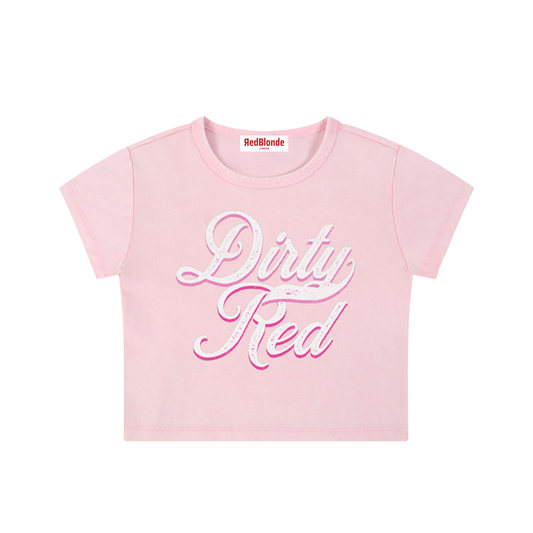 Light pink short-sleeve crop T-shirt with large cursive “Dirty Red” Milkstore text in white and pink on the front, and a small “RedBlonde London” label at the neckline.
