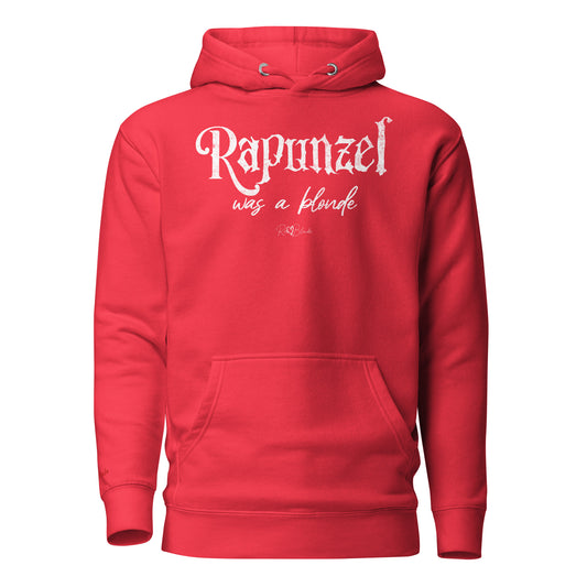 Bold red unisex pullover hoodie with kangaroo pocket and adjustable drawstrings. The front features distressed white lettering that reads “Rapunzel was a blonde” in a mix of gothic and script fonts, with the RedBlonde signature logo beneath. Branded RedBlonde on inside neck and right sleeve