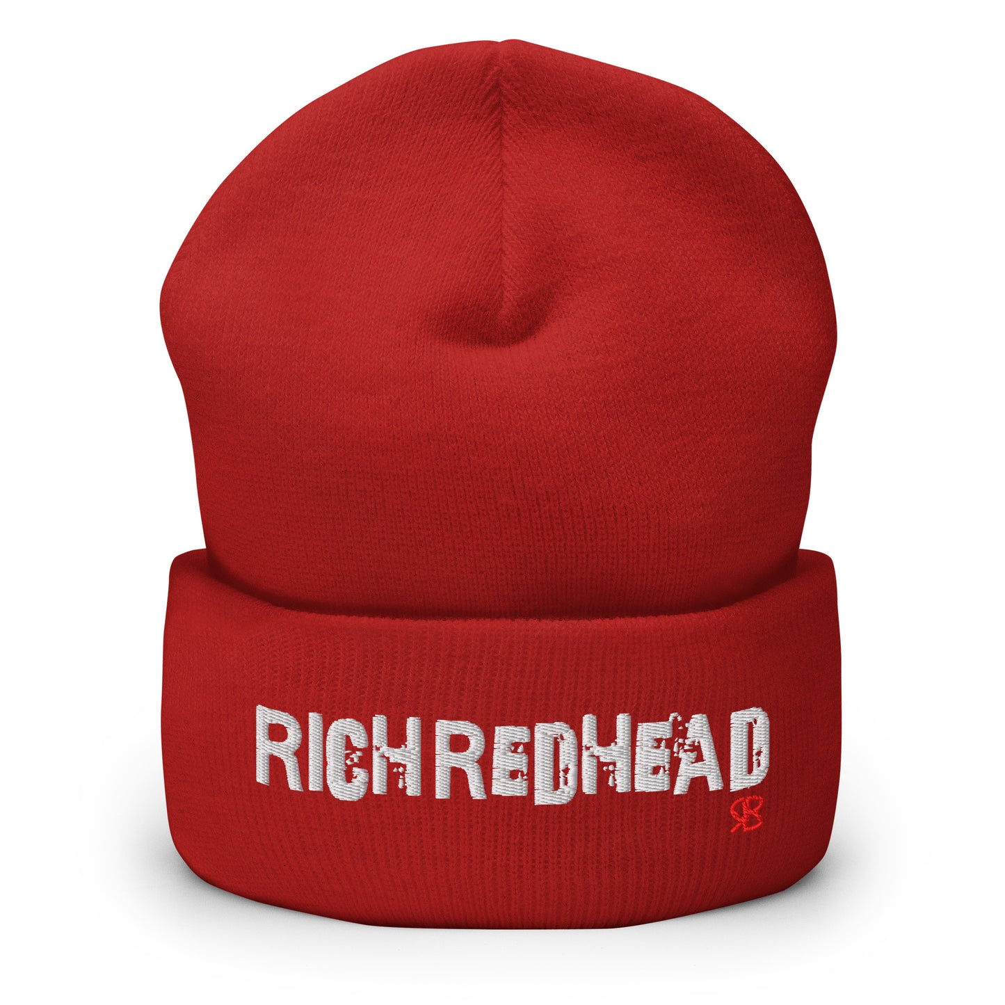 Red cuffed beanie with the embroidered slogan “RICH REDHEAD” in bold white distressed-style lettering, featuring a small red “RB” RedBlonde logo on the right side of the fold. The beanie is shown upright against a clean white background.