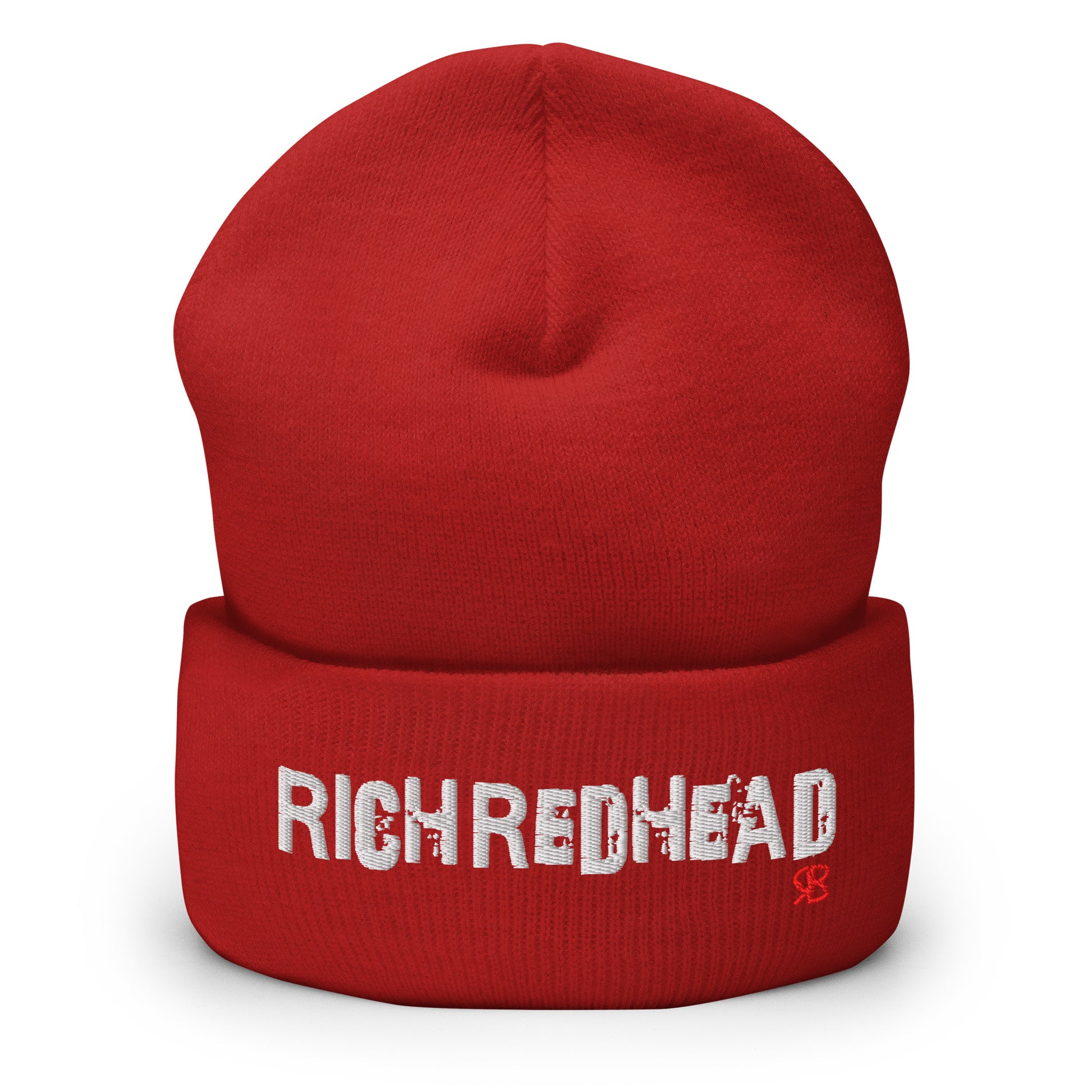 Red cuffed beanie with the embroidered slogan “RICH REDHEAD” in bold white distressed-style lettering, featuring a small red “RB” RedBlonde logo on the right side of the fold. The beanie is shown upright against a clean white background.