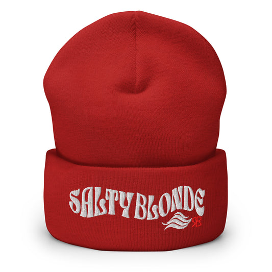 Red cuffed beanie featuring the embroidered phrase “SALTY BLONDE” in textured white lettering with a flowing wave motif and a small red RB logo on the fold.