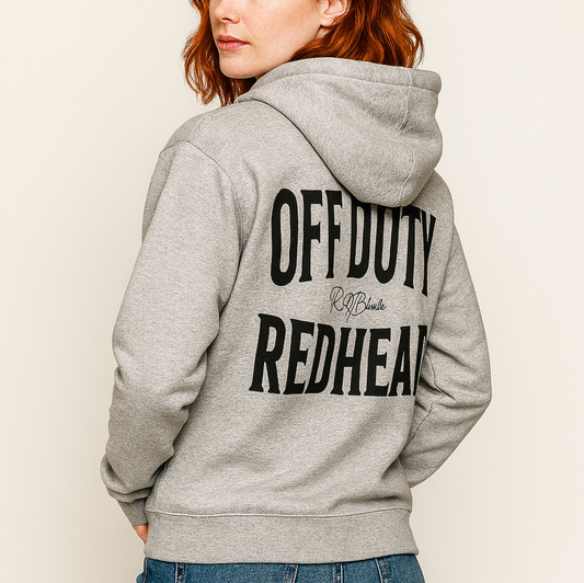 Redhead wears a classic grey unisex hoodie with the words 'OFF DUTY REDHEAD' written in large Brookfield black font, across the back. Branded RedBlonde London in red on inside neck and right sleeve 