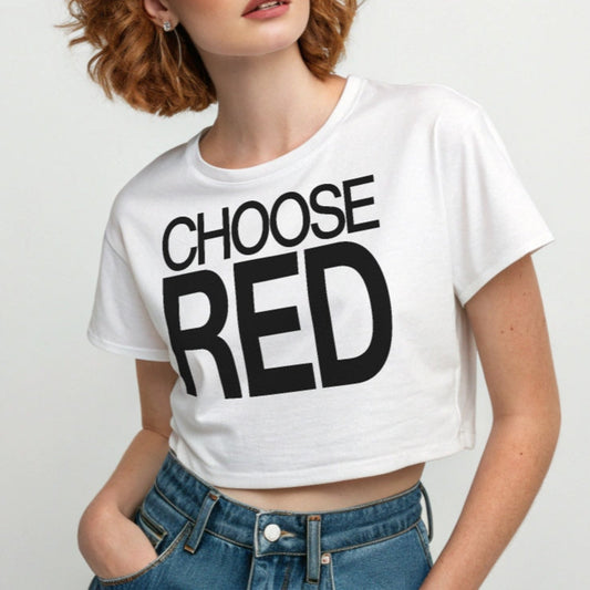 Redhead wears a white women's crop top  graphic t-shirt with “CHOOSE RED” in black Helvetica Now font emblazoned on the front. 