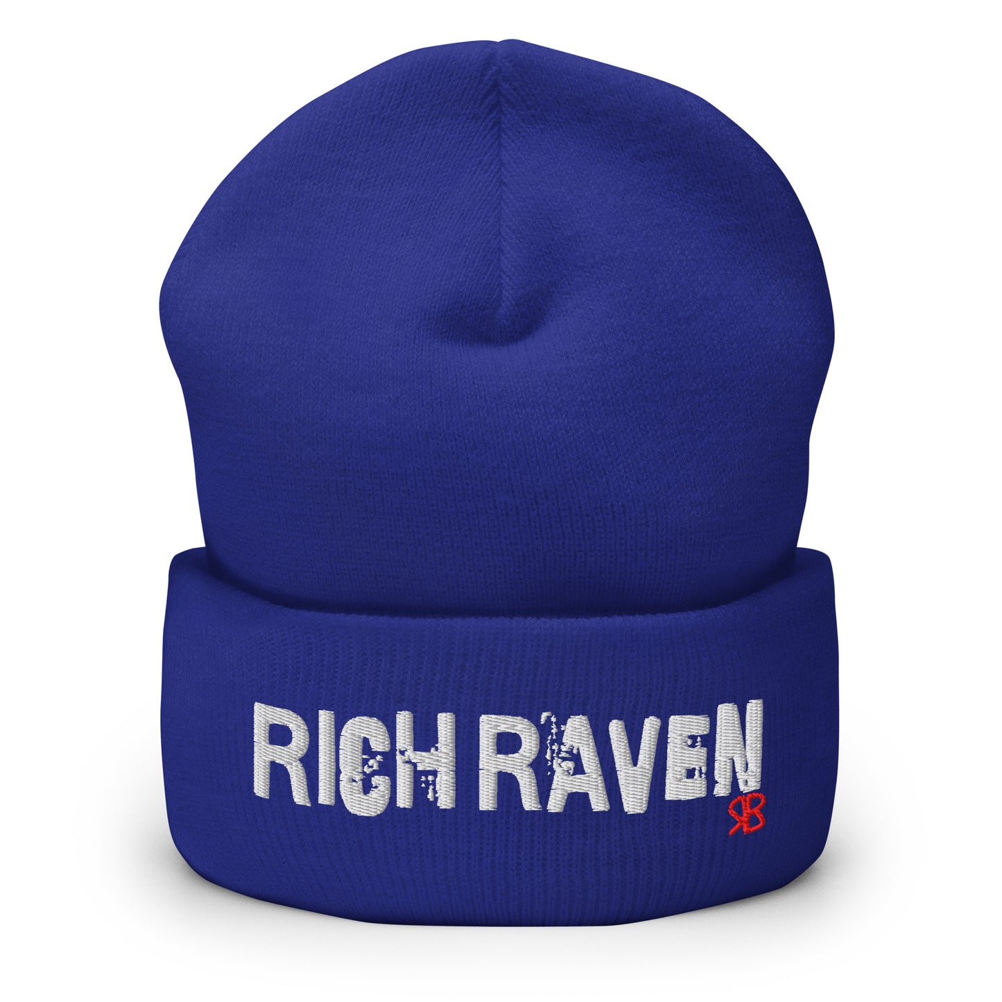 Royal blue knitted beanie with the embroidered phrase “Rich Raven” in white script and a small red RB logo on the fold-over cuff, displayed against a clean white background.