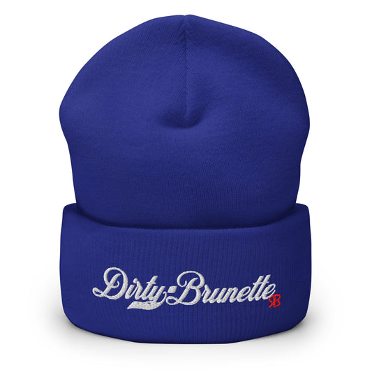 Royal Blue knitted beanie with the embroidered phrase “Dirty Brunette” in white script and a small red RB logo on the fold-over cuff, displayed against a clean white background.