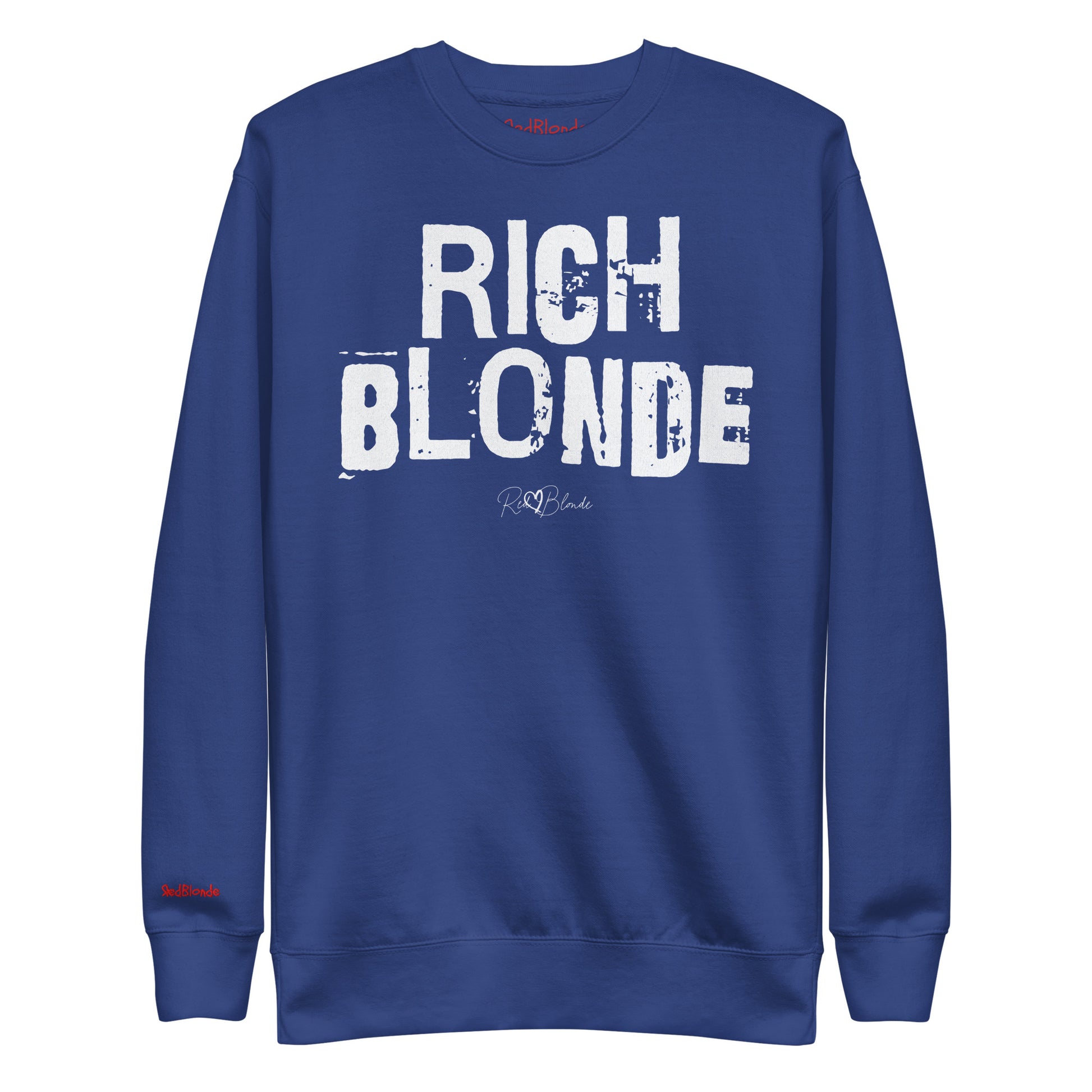 Royal Blue unisex premium sweatshirt with bold distressed white Ed Geinitext “RICH BLONDE” on the front, featuring a subtle RedBlonde logo beneath the lettering and on the sleeve cuff and inside neck