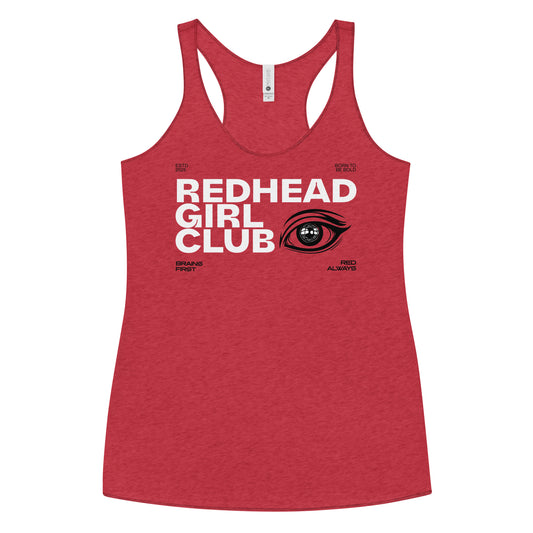 Vintage red women’s racerback tank top with bold white DT Getai Grotesh text reading “Redhead Girl Club” and a stylized black eye graphic to the right. Additional smaller text includes phrases like “Brains First,” “Blonde Always,” “Born to Be Bold,” and “ESTD 2025” arranged around the design.