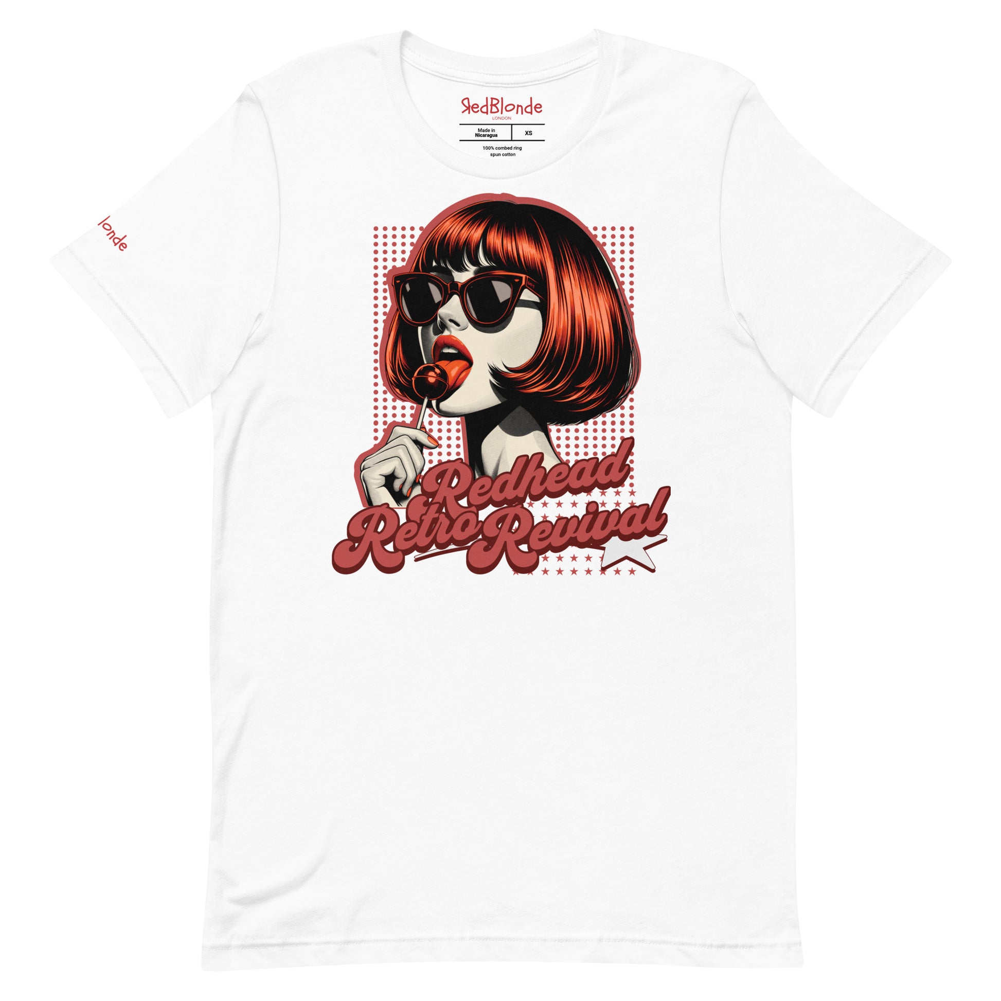 White unisex t-shirt featuring a bold pop-art graphic of a stylish redheaded woman with a sleek bob haircut, red lips, and black sunglasses, holding a lollipop. The design includes red halftone dots and the retro-styled slogan "Redhead Retro Revival" in cursive typography with a star accent. RedBlonde branding appears on the inner neck label and red sleeve in red text.
