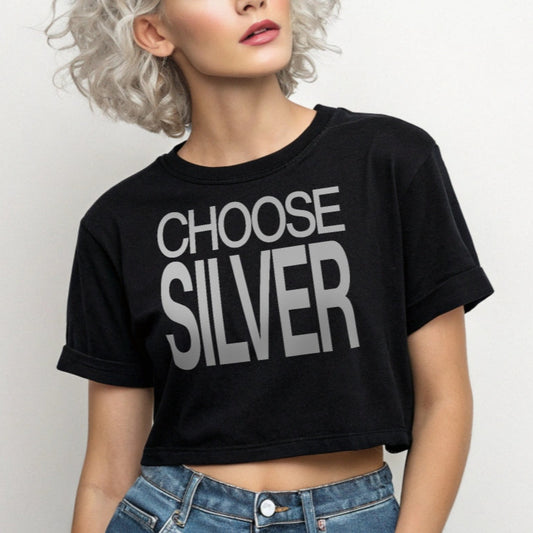 Woman with gray hair wears a black women's crop top  graphic t-shirt with “CHOOSE SILVER” in white Helvetica Now font emblazoned on the front. 