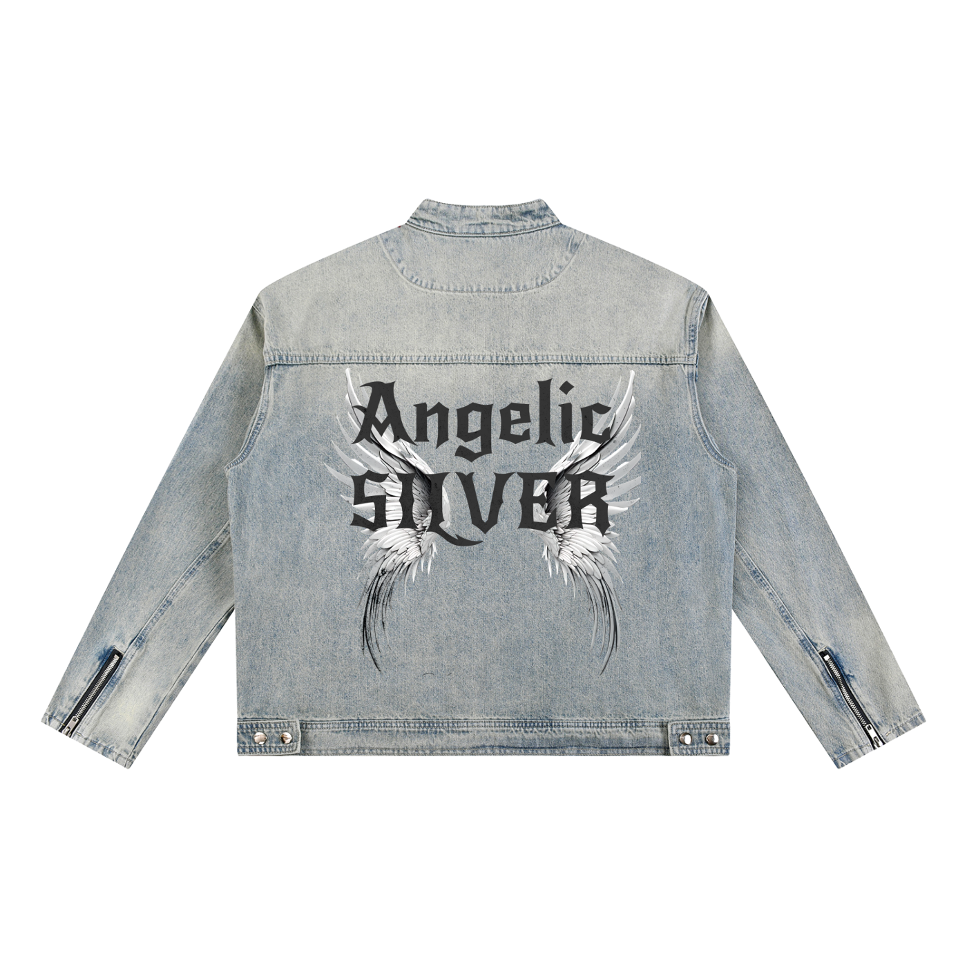 A light-wash denim jacket shown from the back on a white background. The sleeves have zippered cuffs, and the back features a large graphic with white angel wings and black gothic New Rocker style text reading “Angelic SILVER”