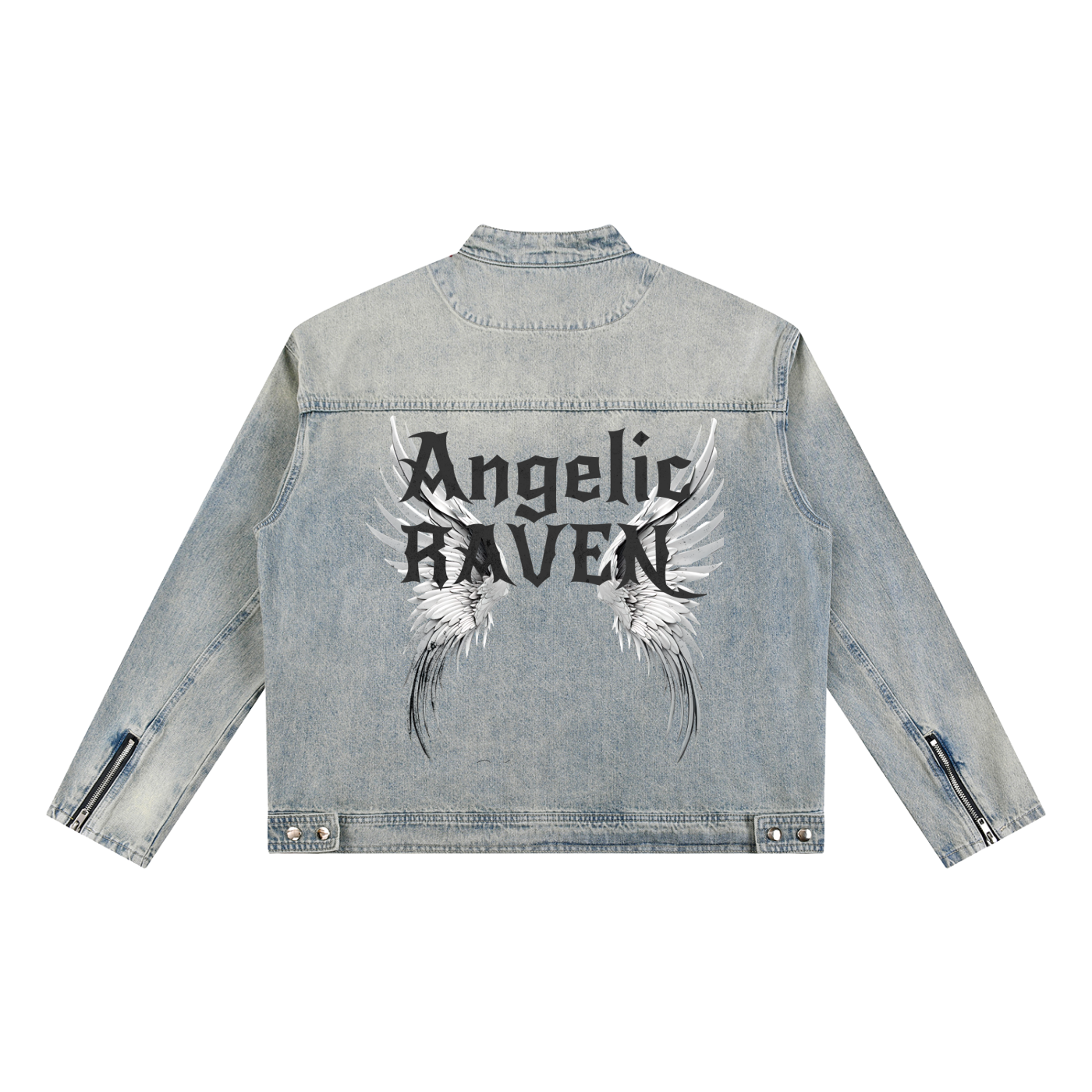 A light-wash denim jacket shown from the back on a white background. The sleeves have zippered cuffs, and the back features a large graphic with white angel wings and black gothic New Rocker style text reading “Angelic RAVEN.”