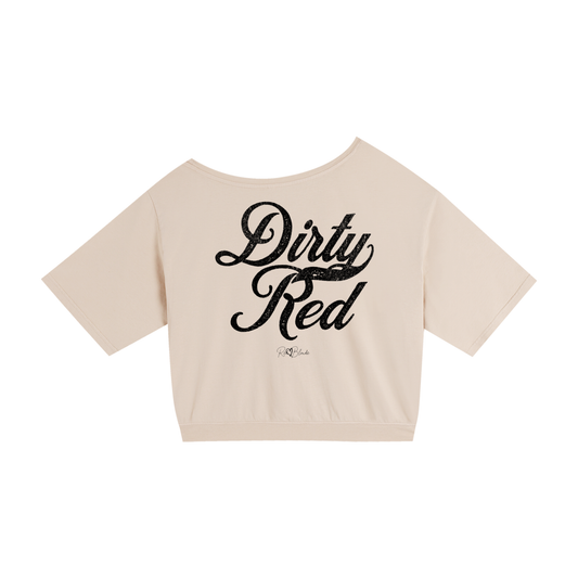 Back view of a apricot asymmetric off-the-shoulder waist length t-shirt featuring the bold white distressed Milkstore font “Dirty Red” with the RedBlonde logo printed below. The relaxed, oversized fit and one-shoulder neckline give it a modern, effortless look.