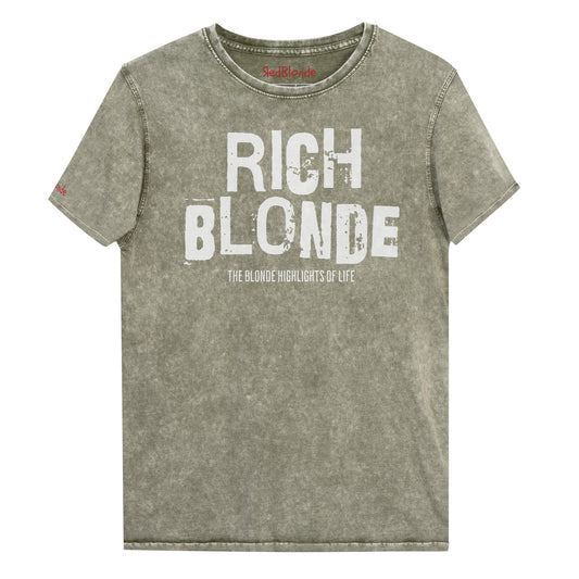 An army green acid-wash unisex denim T-shirt with a distressed vintage look. The shirt features the bold white text “RICH BLONDE” in a weathered Ed Gein font, with the tagline “THE BLONDE HIGHLIGHTS OF LIFE” in smaller uppercase letters below. The shirt has short sleeves, a crew neckline, and visible seam detailing for a rugged, casual style. Branded Redblonde on inside neck and right sleeve