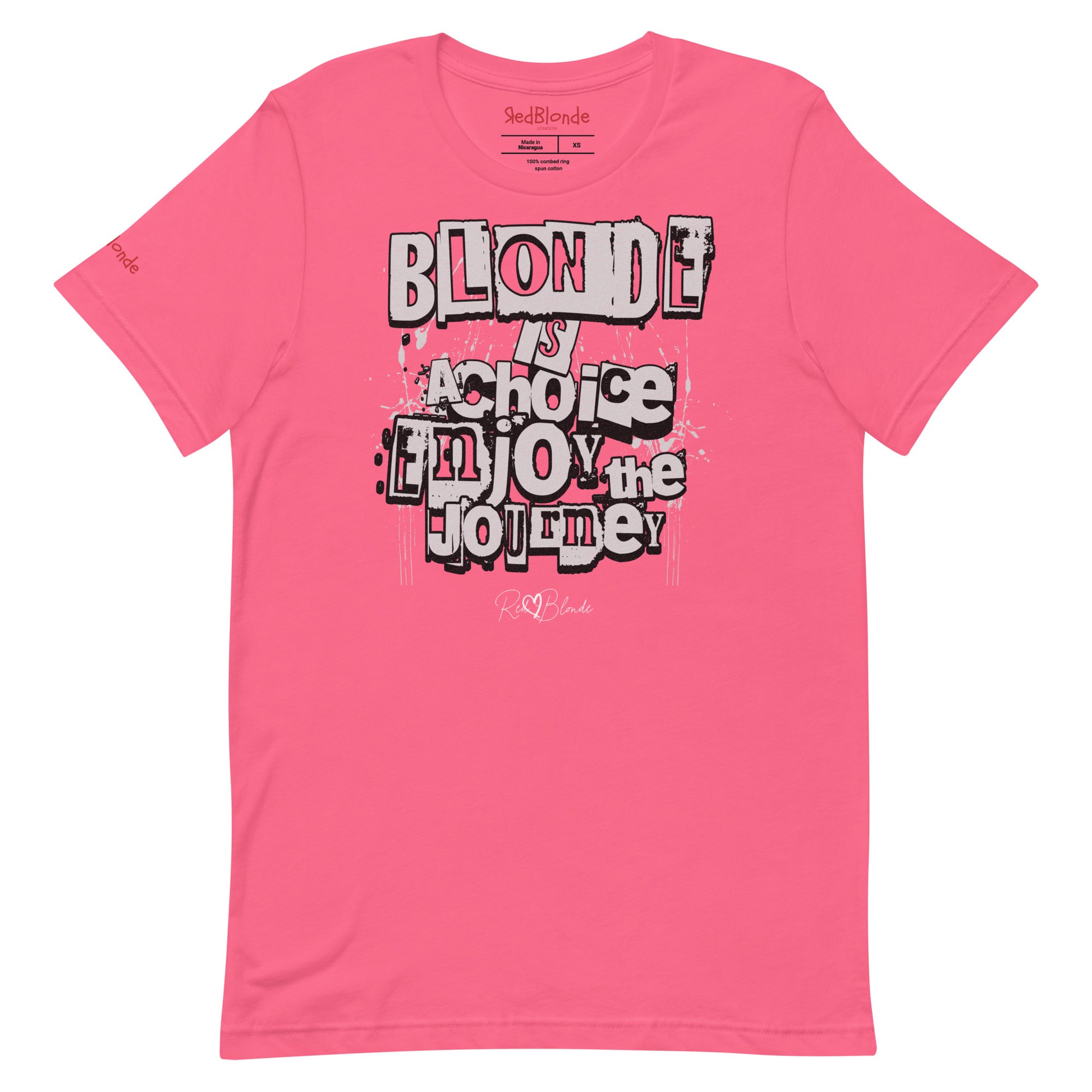 A berry pink unisex T-shirt with a classic crew neckline and short sleeves. The front displays a bold, graffiti-style text design in black, white, and gray. The words read: “BLONDE is a choice, ENJOY the JOURNEY” with varied fonts and a layered street-art effect. The RedBlonde brand name is subtly printed below in a handwritten script. Branded RedBlonde london in red on inside neck and right sleeve