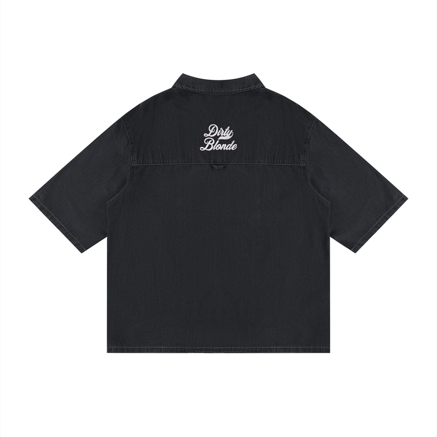back view of a black, short-sleeve button-up shirt with a subtle faded finish and a small raised “Dirty Blonde” Milkstore script logo centered across the upper back.