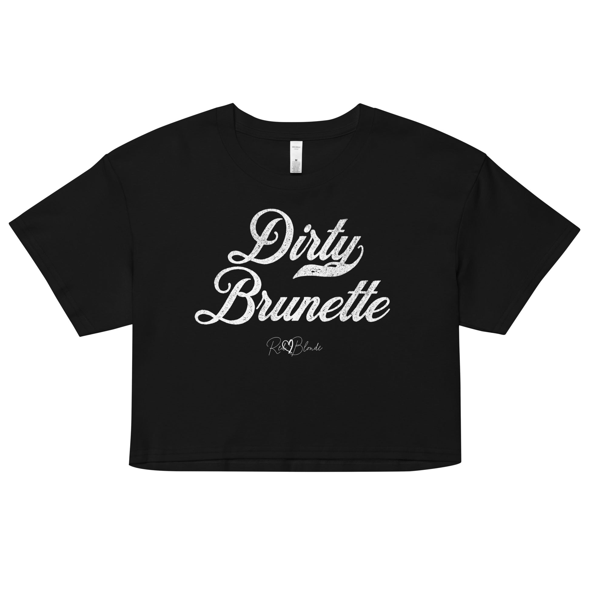 black women’s crop top featuring the phrase “Dirty Brunette” in bold, white milkstore vintage-style script across the chest. Below the phrase, the brand name “RedBlonde” is printed in a smaller, elegant handwritten font.