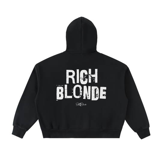 Black hem to hood zip-up hoodie with cropped oversized fit and ribbed cuffs/hem, featuring large distressed white “RICH BLONDE” Ed Gein text across the back with a small “RedBlonde” script logo beneath.