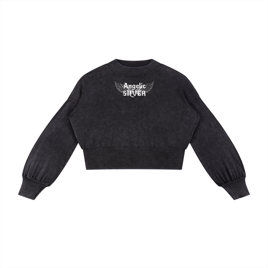 black mineral-wash cropped sweater with balloon sleeves, ribbed collar/cuffs/waistband, and a white “Angelic silver” wing graphic on the chest, shown on a white background.