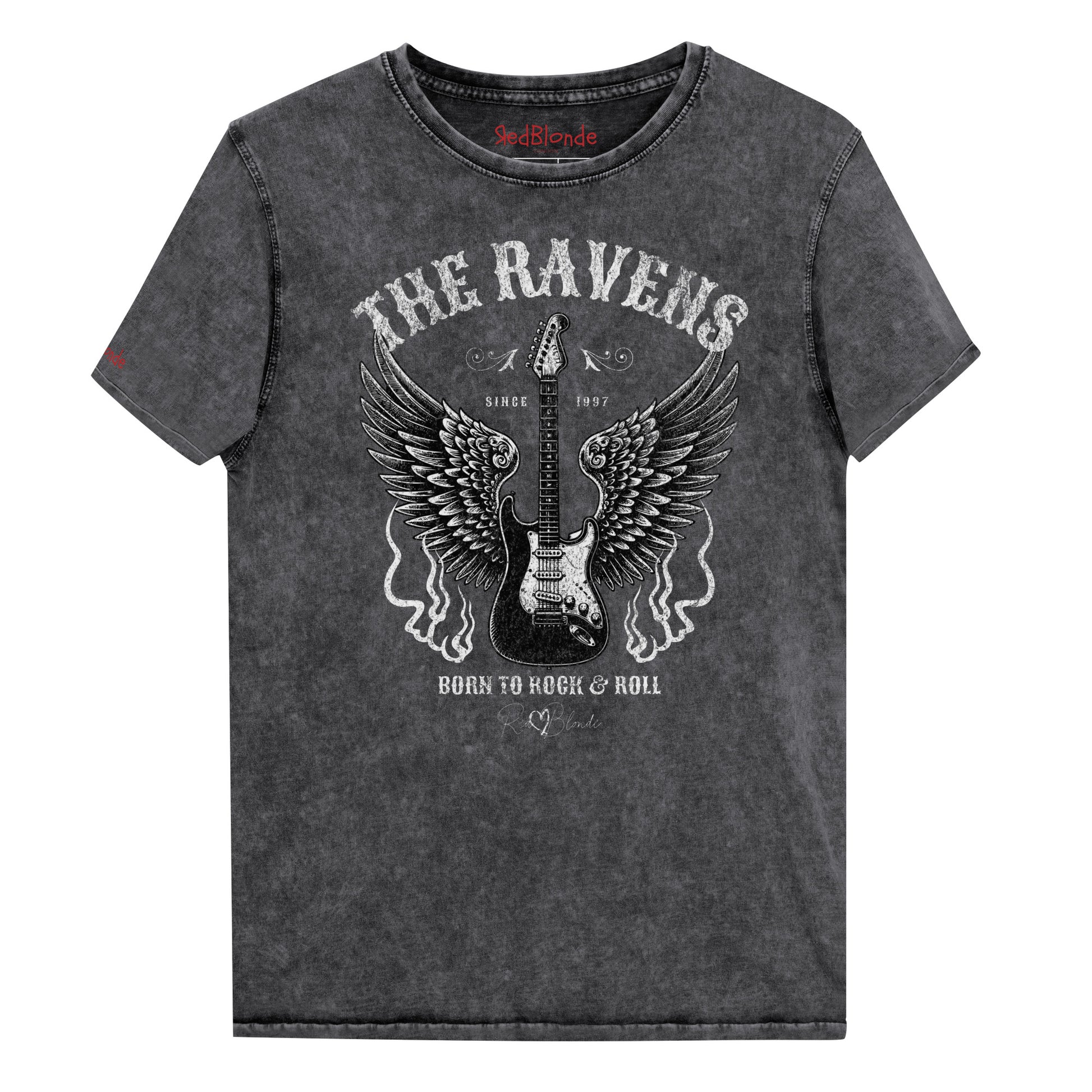 A flatlay of a black denim wash unisex t-shirt with a graphic of a black & white guitar with raven bird wings emerging from the side. The graphic features ‘THE RAVENS’ in Sancreek font in a semicircle above the guitar, while ‘BORN TO ROCK & ROLL’ is underneath. Branded RedBlonde London in inside neck and right sleeve