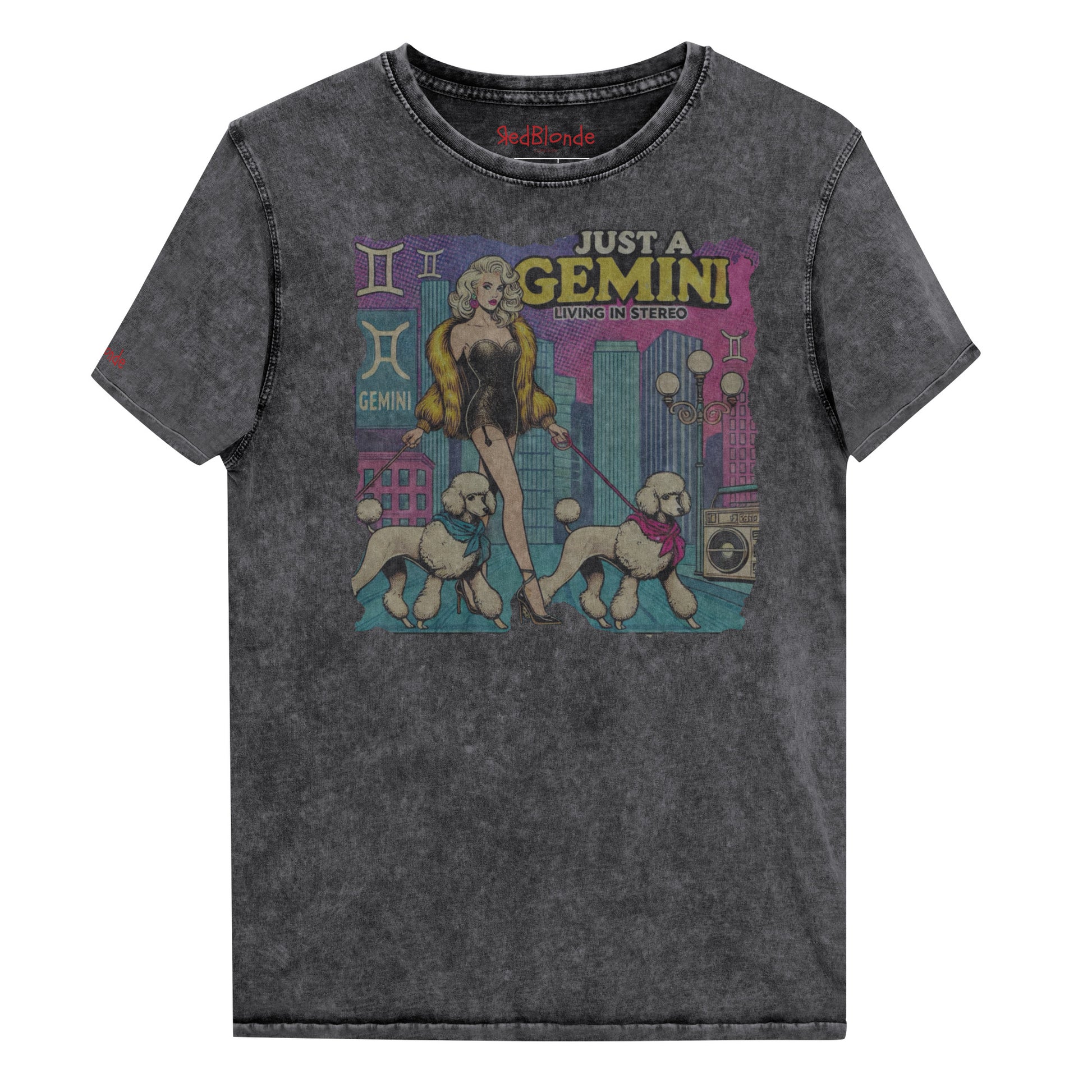Flatlay of a unisex black denim wash vintage t-shirt with a retro pop-art Gemini graphic featuring a blonde woman, in a short catsuit and fur coat walking two poodle dogs with neck scarfs with a city backdrop and a gettoblaster ‘Just a Gemini, Living in Stereo'. Branded RedBlonde on inside neck and right shoulder
