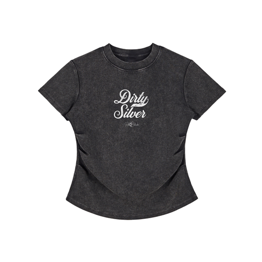 A fitted, short-sleeve black crewneck T-shirt laid flat on a white background. It has subtle ruching/contouring at the sides and a slightly curved hem. white script text across the chest reads “Dirty Silver,” in Milkstore 01 script with a small cursive “RedBlonde” logo beneath.