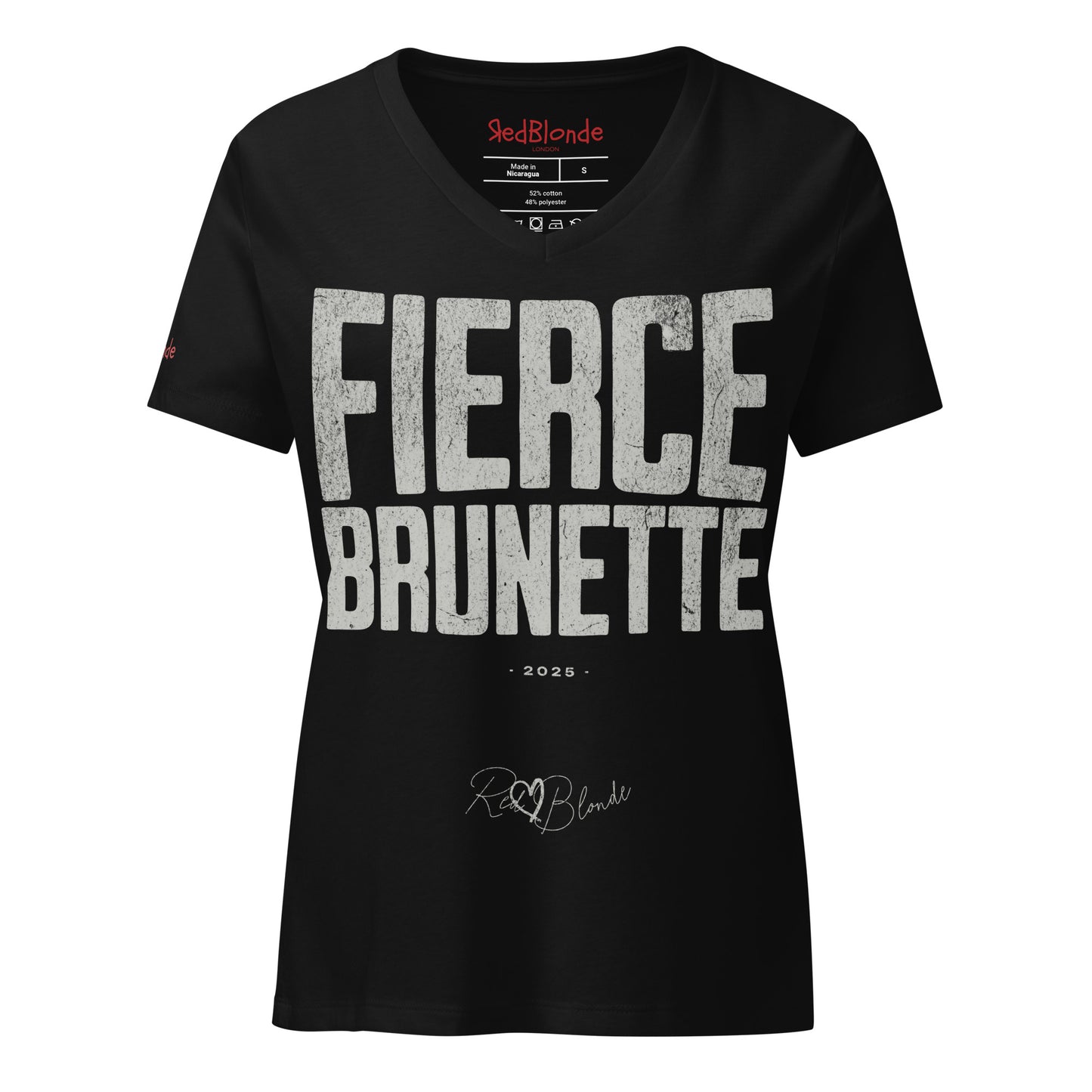 black women’s V-neck T-shirt featuring the bold black distressed text “FIERCE BRUNETTE” in large North Road capital letters across the chest. Beneath the text, the year “2025” is printed in small type, with the “RedBlonde” brand signature logo below it. The inner collar shows the “RedBlonde” brand name in red along with sizing and care details, and “RedBlonde” is also printed in small red letters on the right sleeve.