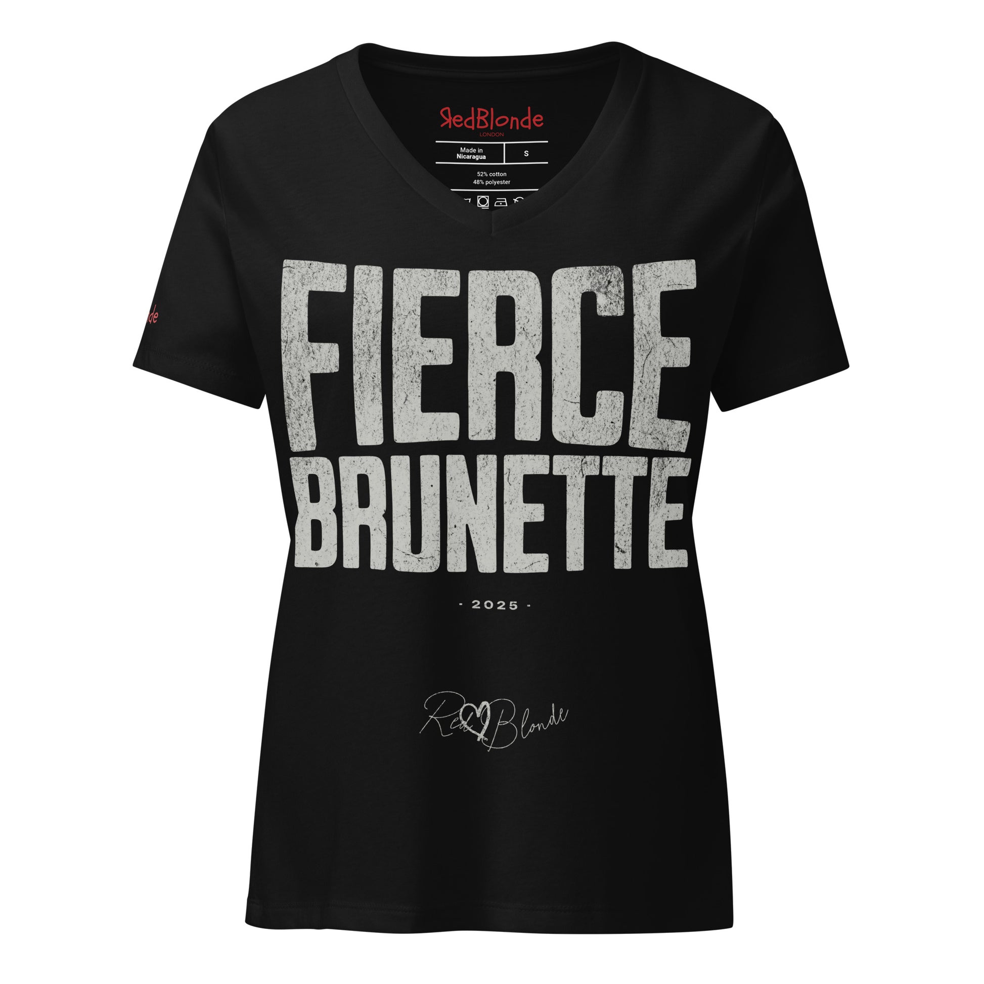 black women’s V-neck T-shirt featuring the bold black distressed text “FIERCE BRUNETTE” in large North Road capital letters across the chest. Beneath the text, the year “2025” is printed in small type, with the “RedBlonde” brand signature logo below it. The inner collar shows the “RedBlonde” brand name in red along with sizing and care details, and “RedBlonde” is also printed in small red letters on the right sleeve.