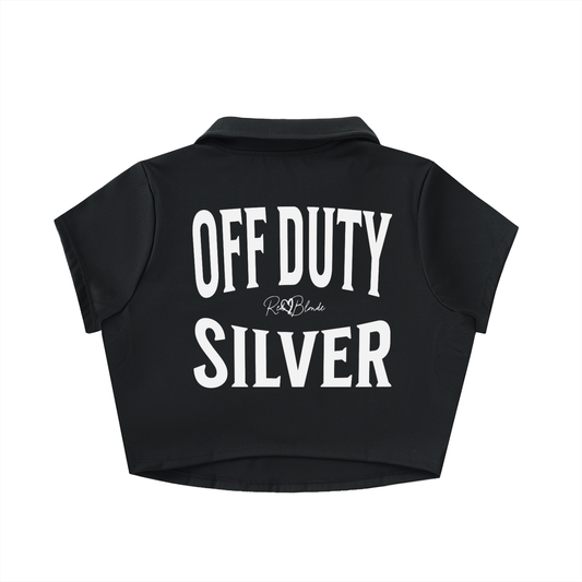 black cropped polo shirt with large white “OFF DUTY SILVER” Brookfield text on the back and a small RedBlonde script logo beneath.