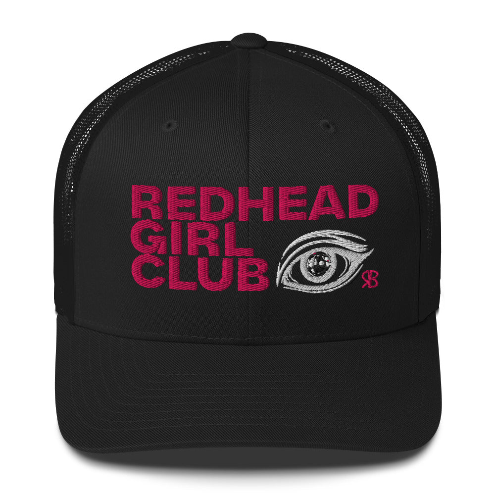Black mesh trucker hat featuring bold red embroidered text “Redhead Girl Club” alongside a detailed embroidered eye graphic and a small red RB logo.