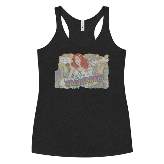 Flatlay of a heather black soft racerback tank t-shirt with a retro pop-art redhead Sagittarius graphic featuring a redhead woman, with bow & arrows, white stallion, and a city backdrop, captioned ‘Just a Sagittarius, armed with a bow & dreams'