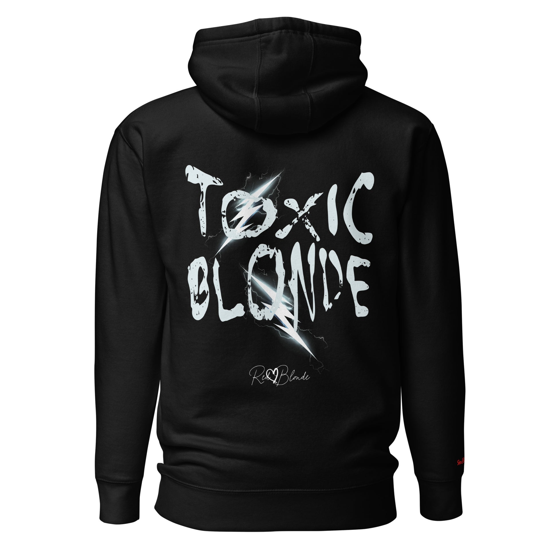Back view of a black unisex hoodie featuring bold distressed white Chainsaw Carnage text reading “Toxic Blonde” with lightning-style accents and the RedBlonde signature logo underneath. The design has an edgy, electric aesthetic.Branded RedBlonde in red on right sleeve