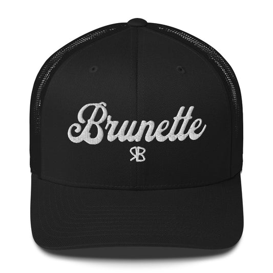 black trucker cap with 'Brunette' in white adventurer 01 font on front. Branded RB