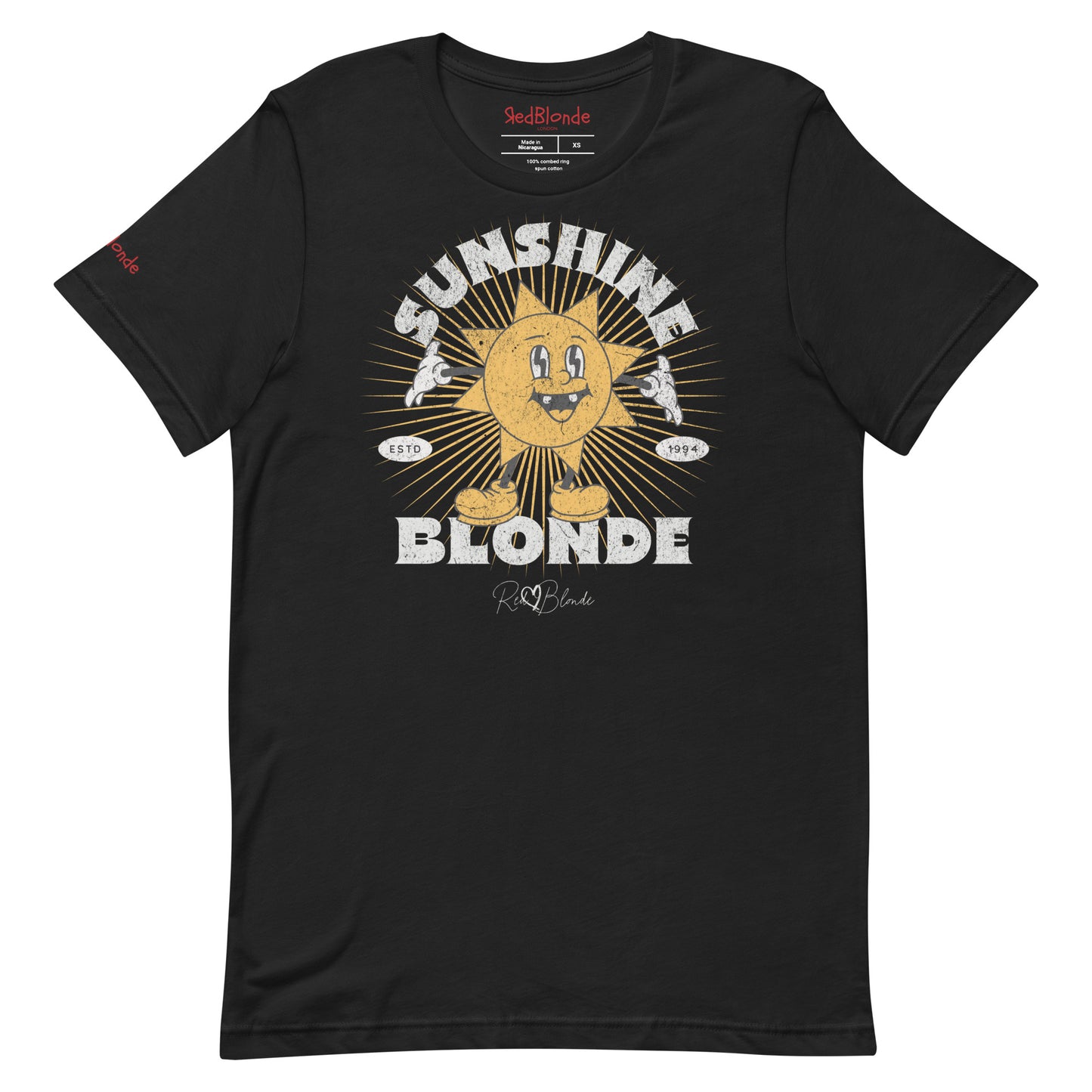 Black unisex crew neck t-shirt with a retro cartoon-style yellow sun character, smiling with open arms, surrounded by radiant sunbeams. The text reads ‘Sunshine Blonde’ in bold vintage Belzebuth lettering, with small details including ‘ESTD 1994’ and the RedBlonde signature logo beneath."