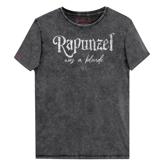 black unisex acid denim wash tshirt featuring white fairytale spiky text that reads “Rapunzel" and the phrase “was a blonde” written underneath in an elegant cursive script. signed off with the RedBlonde heart signature logo. Branded RedBlonde on inside neck and right sleeve