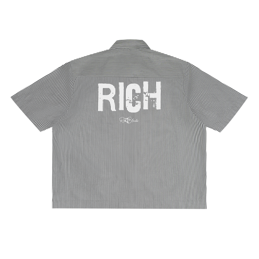Back view of a black and white pinstriped short-sleeve button-up shirt with a large distressed white “RICH” Ed Gein font print across the upper back and a small RedBlonde script logo underneath.
