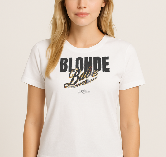 Blonde wears a White unisex T-shirt with bold black and gold vintage lettering that reads ‘Blonde Babe’ across the chest, in Anton text for 'babe' and Milkstore 01 script for  ‘Babe’ with a swoosh underline and the RedBlonde signature logo beneath. Branded Redblonde on inside neck and right sleeve