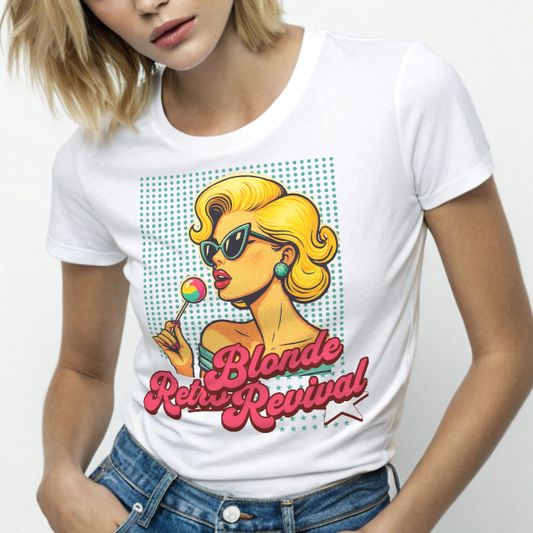 blonde wears a White unisex t-shirt featuring a vibrant retro pop art illustration of a glamorous blonde woman in sunglasses holding a lollipop, with bold red script text that reads "Blonde Retro Revival." Branded RedBlonde on inside neck and right sleeve 