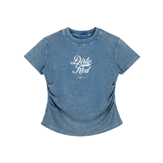 A fitted, short-sleeve blue crewneck T-shirt laid flat on a white background. It has subtle ruching/contouring at the sides and a slightly curved hem. White script text across the chest reads “Dirty Red,” in Milkstore 01 script with a small cursive “RedBlonde” logo beneath.