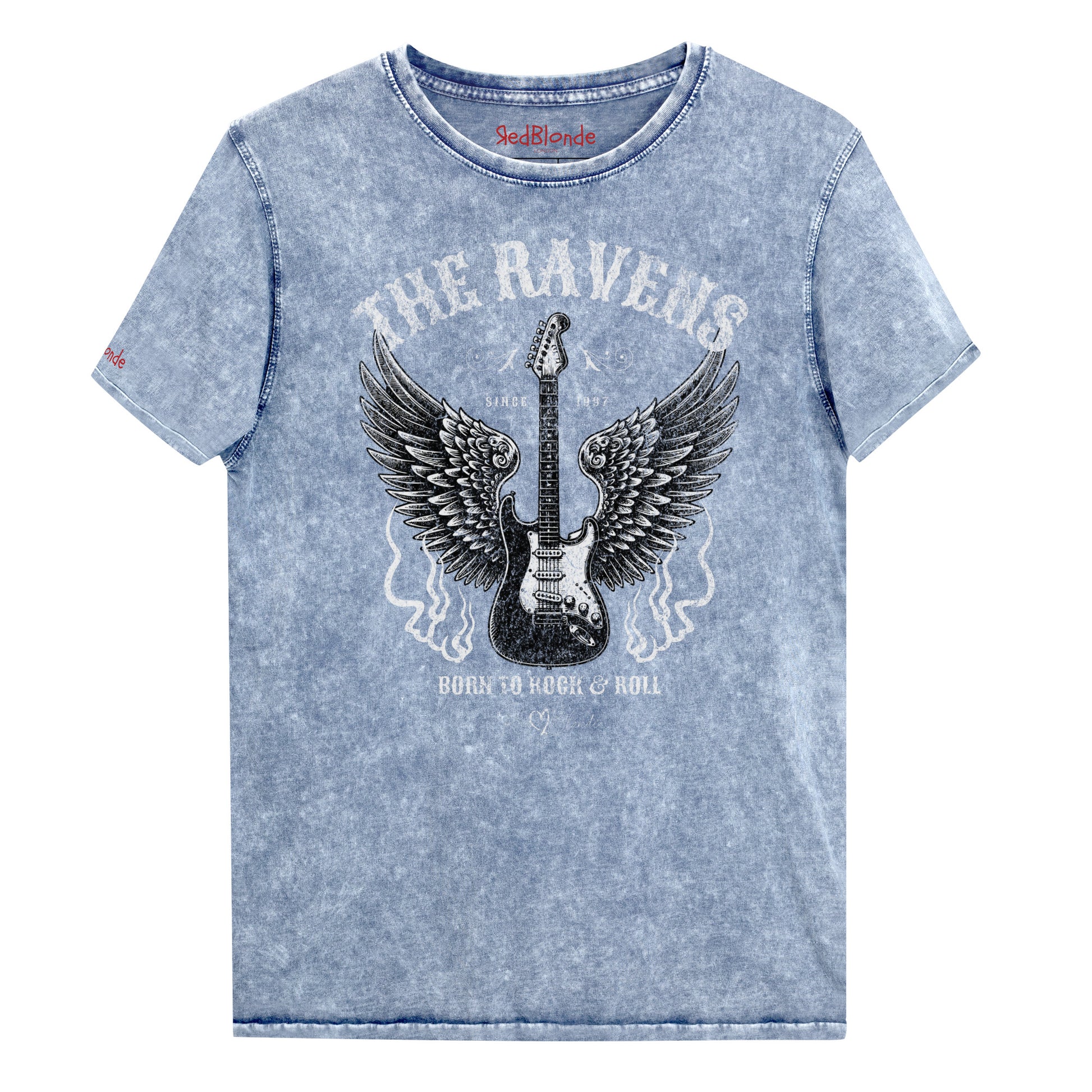 Flatlay of blue denim wash unisex t-shirt with a graphic of a black & white guitar with raven bird wings emerging from the side. The graphic features ‘THE RAVENS’ in Sancreek font in a semicircle above the guitar, while ‘BORN TO ROCK & ROLL’ is underneath. Branded RedBlonde London in inside neck and right sleeve