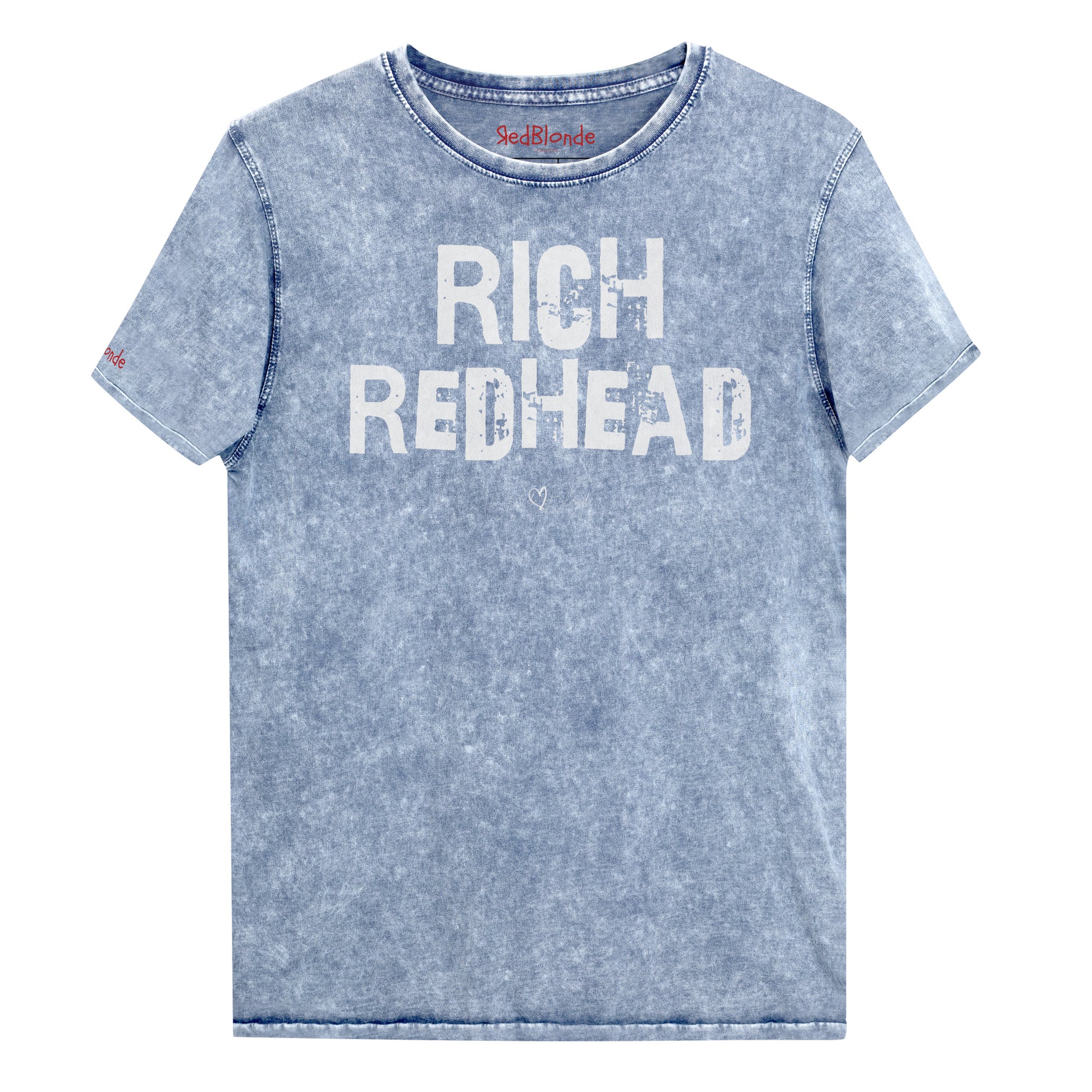 a blue acid-wash unisex denim T-shirt with a distressed vintage look. The shirt features the bold white text “RICH REDHEAD” in a weathered Ed Gein font, and features the RedBlonde signature logo. The shirt has short sleeves, a crew neckline, and visible seam detailing for a rugged, casual style. Branded Redblonde on inside neck and right sleeve